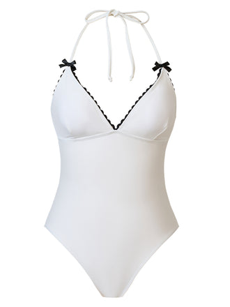 She's wearing White 1950s Bow Lace-Up Halter Swimsuit and the whole beach remembers the 1950s
