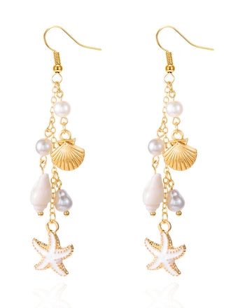Gold and pearl earrings with starfish and shell designs on a white background