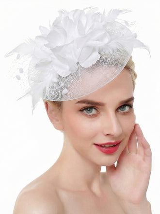 Elegant vintage bridal fascinator featuring delicate mesh veil with silk flowers and feathers, perfect for wedding ceremonies and special occasions