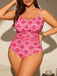 Woman wearing a pink and red patterned swimsuit against a neutral background