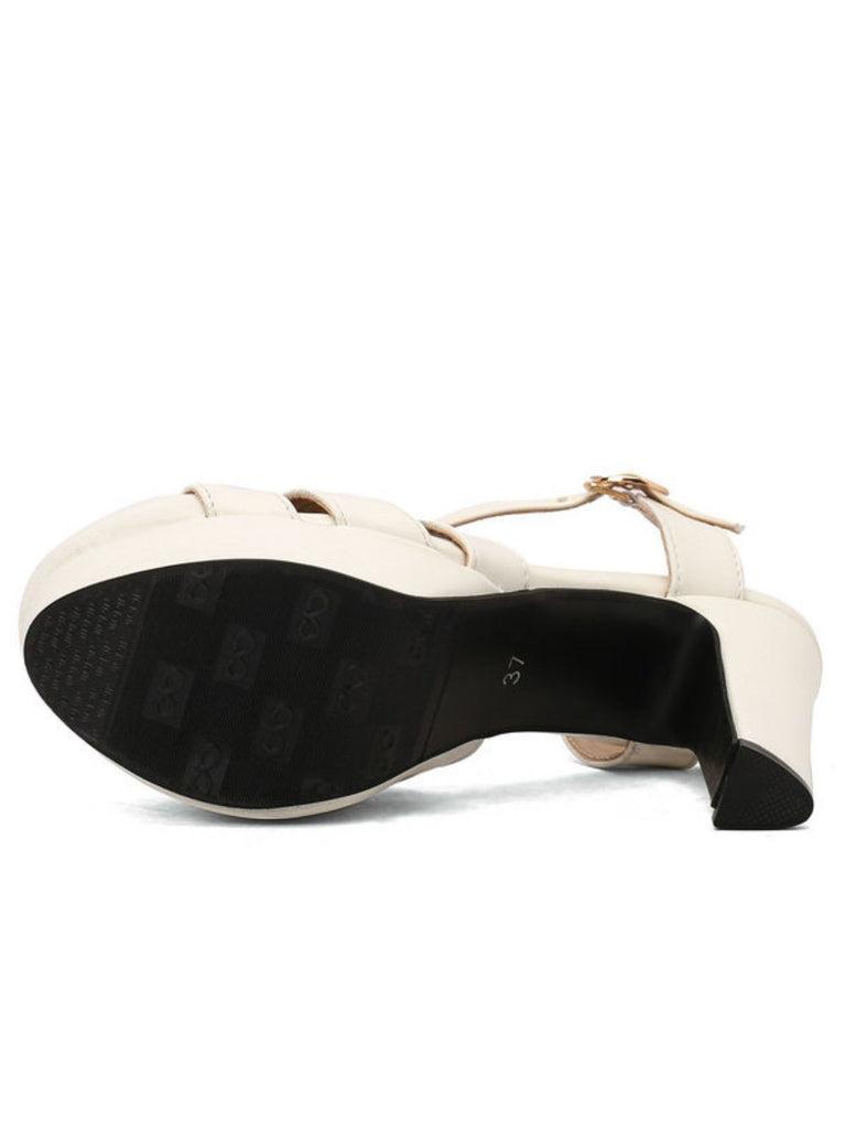 View of the anti-slip black rubber sole on the bottom of the white platform high-heeled sandals.