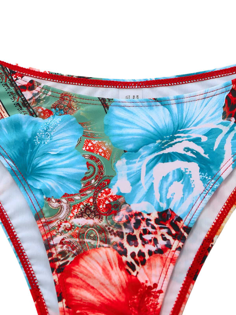 Detail shot of the bikini bottom's waistband featuring a bright blue hibiscus floral design.