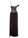 Side-angled view of the brown maxi dress showcasing the single spaghetti strap and off-the-shoulder draped sleeve.