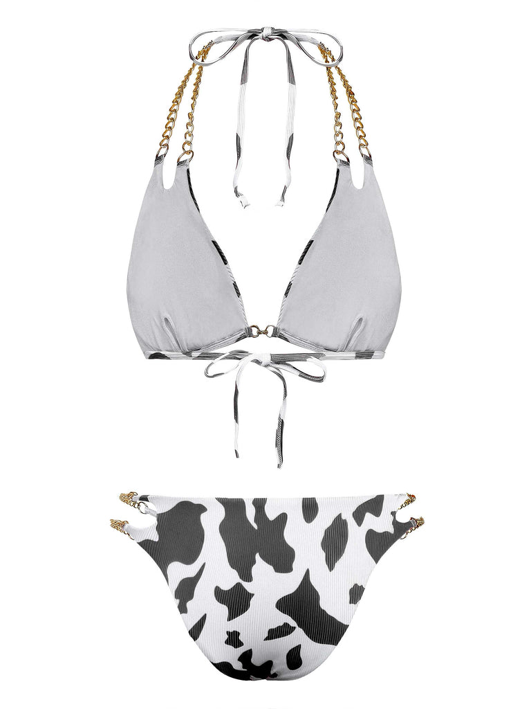 Back view of the black and white cow print bikini showcasing the tie closures and gold chain strap detailing.