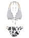 Back view of the black and white cow print bikini showcasing the tie closures and gold chain strap detailing.