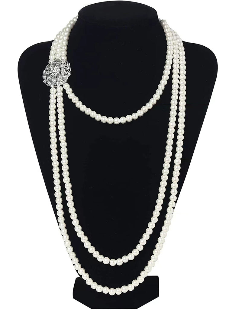 A Great Gatsby style long multi-strand pearl necklace displayed on a black mannequin, highlighting its elegant drape.
