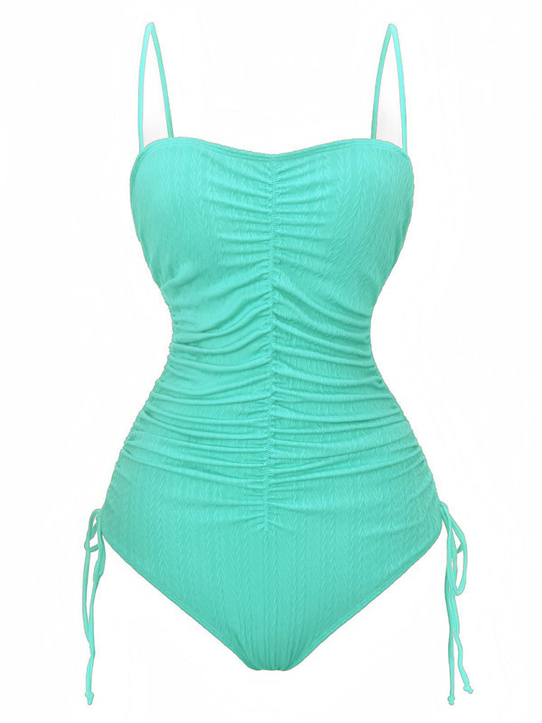 Mint green swimsuit with ruched design on a white background