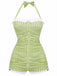 A vintage-style one-piece swimsuit with a halter neck and bowknot detail, featuring a vibrant green and white gingham pattern.
