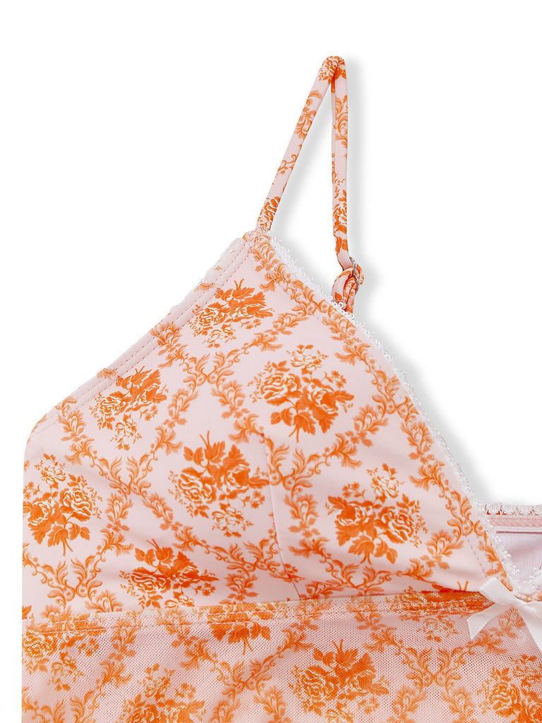White bikini top with orange floral pattern on a white background