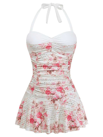 Front studio view of the floral swimsuit highlighting the ruched bodice and the flared skirt hem.