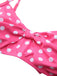 A detailed shot of the interior lining and edge stitching of the pink polka dot bikini top.