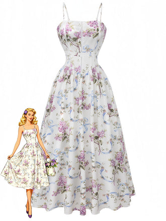 A white A-line midi dress featuring a romantic print of purple flowers and blue ribbons, styled with spaghetti straps and a cinched waist, shown with a retro fashion illustration.