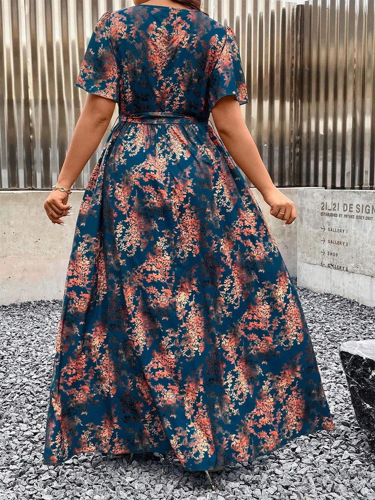 Rear view of the floral wrap maxi dress showcasing the flutter sleeves and continuous botanical pattern.