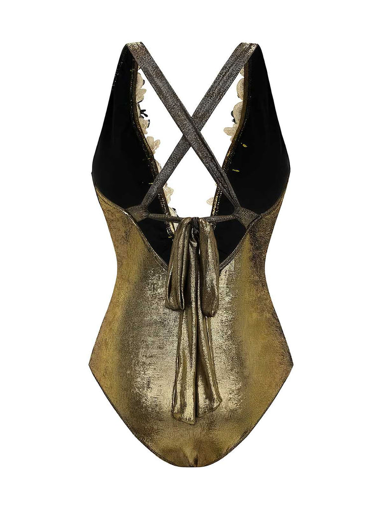 Rear view of the gold one-piece swimsuit alone, showcasing the elegant strappy back design and high-cut leg.