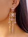 Side view of a model wearing one of the large rhinestone skeleton earrings to show scale and how they hang.