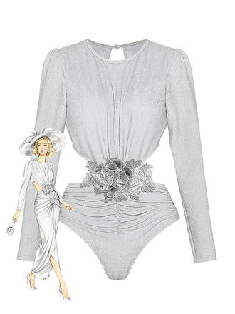 A elegant two-piece silver shimmer set featuring a long-sleeve bodysuit with a cut-out waist, a floral belt, and a matching long draped skirt, shown with a vintage illustration.