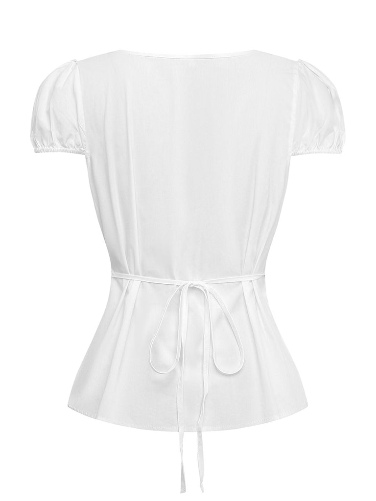 Rear view of the white retro blouse showcasing the clean back design and the elegant fit-and-flare waist construction.