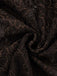 Macro view of the intricate floral lace pattern over the dark brown base fabric.