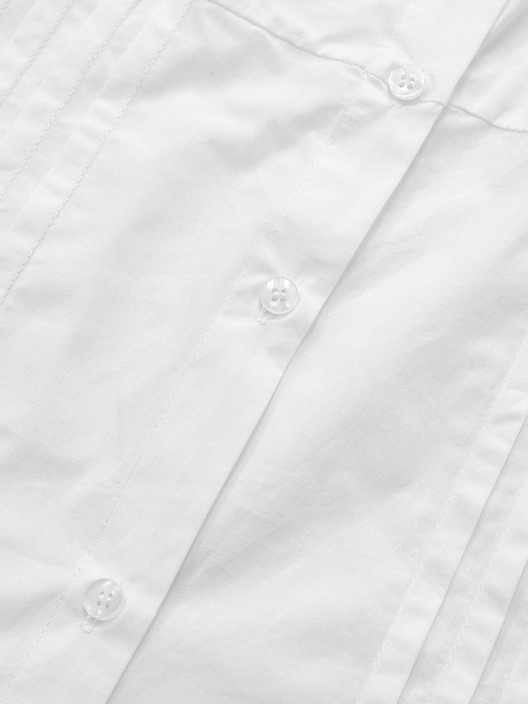 Macro view of the white cotton-blend fabric and the neat button-down front along the ruched waist section.