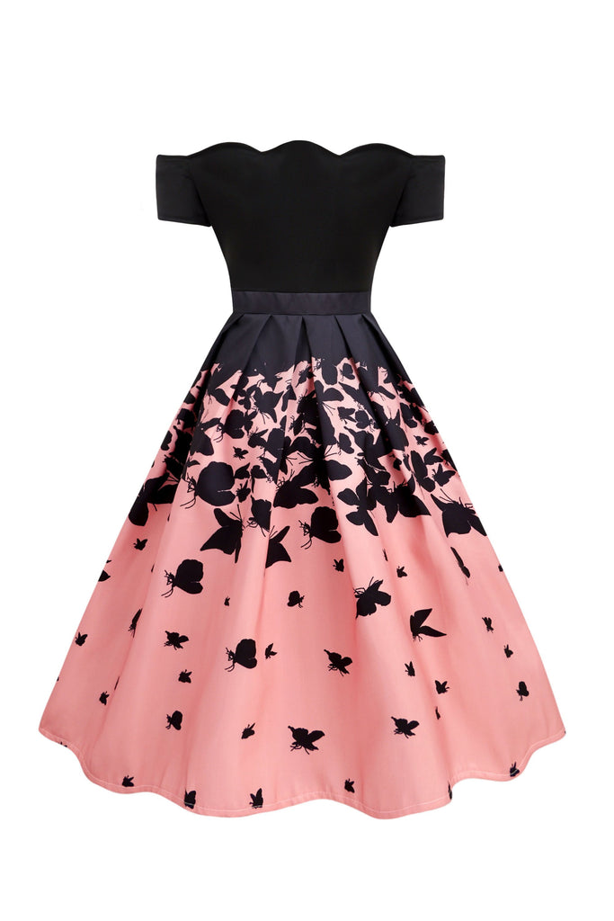 She wears Black 1950s Butterfly Swing Dress with vintage grace