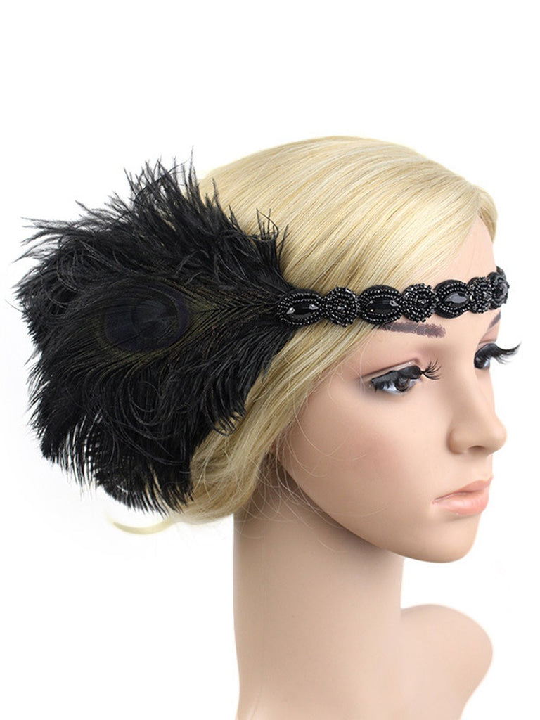 A black feather elastic headband featuring a peacock-style feather and beaded detailing, styled on a mannequin for a 1920s Great Gatsby look.